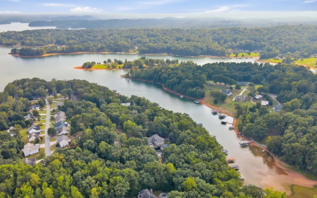 Aerial view of a Lake Lanier cove with private docks and exposed red clay shoreline at lower water levels